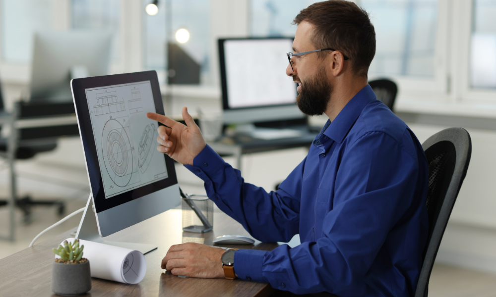 Alt-text- CAD drafter creating precise building drawing in design software